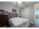 Teen bedroom with hardwood floors, a dresser, a queen-size bed, and an ensuite entrance at 3144 Mountain Spruce Ter, Wesley Chapel, FL 33543