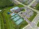 An aerial view of the community center including a pool, basketball court, and tennis courts at 3144 Mountain Spruce Ter, Wesley Chapel, FL 33543