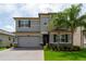 Beautiful two-story home with a well-maintained front yard and a paved driveway at 3144 Mountain Spruce Ter, Wesley Chapel, FL 33543