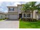Charming two-story home with a well-manicured front yard and a paved driveway at 3144 Mountain Spruce Ter, Wesley Chapel, FL 33543