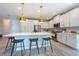 Spacious kitchen featuring white cabinets, stainless steel appliances, and a large island with barstool seating at 3144 Mountain Spruce Ter, Wesley Chapel, FL 33543