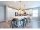 Bright kitchen featuring a large center island with pendant lights and seating for casual dining at 3144 Mountain Spruce Ter, Wesley Chapel, FL 33543