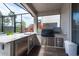 Outdoor kitchen on a screened patio with stainless steel appliances and counter space at 3144 Mountain Spruce Ter, Wesley Chapel, FL 33543