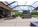 Relaxing screened-in patio area with brick floors and hot tub at 3144 Mountain Spruce Ter, Wesley Chapel, FL 33543