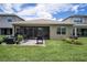 Enjoy outdoor living on the patio and screened in porch surrounded by a lush lawn at 3318 Woodland Brook Way, Wesley Chapel, FL 33543
