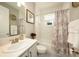 Clean bathroom with a shower-tub combo and stylish vanity at 3318 Woodland Brook Way, Wesley Chapel, FL 33543