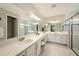 Well-lit bathroom featuring double sinks, spacious counters, and tiled floors at 3318 Woodland Brook Way, Wesley Chapel, FL 33543