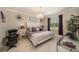 Tastefully decorated bedroom with a modern chandelier, tile floors, and a comfortable sitting area at 3318 Woodland Brook Way, Wesley Chapel, FL 33543
