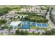 Aerial view of the community amenities featuring a pool, tennis courts, basketball court, and playground at 3318 Woodland Brook Way, Wesley Chapel, FL 33543