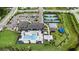 Aerial view of the community pool, splash pad, clubhouse, parking, tennis and basketball courts at 3318 Woodland Brook Way, Wesley Chapel, FL 33543