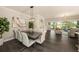 Dining area featuring a modern table, white chairs, and decorative wall art at 3318 Woodland Brook Way, Wesley Chapel, FL 33543