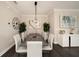 Dining room with modern chandelier, and gray-topped table at 3318 Woodland Brook Way, Wesley Chapel, FL 33543