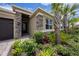 Home exterior showcasing stone accents, manicured landscaping, and a charming front entrance at 3318 Woodland Brook Way, Wesley Chapel, FL 33543