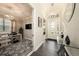 Bright foyer with a decorative front door, opening into a view of the office and other rooms at 3318 Woodland Brook Way, Wesley Chapel, FL 33543