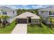 Charming single-Gathering home boasts a well-manicured lawn, stone accents, and a two-car garage at 3318 Woodland Brook Way, Wesley Chapel, FL 33543