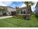 Beautiful home with a paver driveway, lush landscaping, and mature palm trees, offering a welcoming curb appeal at 3318 Woodland Brook Way, Wesley Chapel, FL 33543