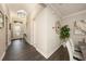 Hallway with dark wood-look flooring and views into the dining and living rooms at 3318 Woodland Brook Way, Wesley Chapel, FL 33543