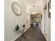 Bright hallway with modern decor, light gray walls, and dark wood-look floors at 3318 Woodland Brook Way, Wesley Chapel, FL 33543