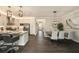 Open concept kitchen and dining room featuring white cabinets, stainless steel appliances, and a dining table for six at 3318 Woodland Brook Way, Wesley Chapel, FL 33543