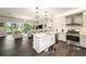 Open concept kitchen with stainless steel appliances, island, and views to the patio at 3318 Woodland Brook Way, Wesley Chapel, FL 33543