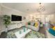 Bright living room showcasing modern decor, hardwood floors, and an open concept design to the kitchen at 3318 Woodland Brook Way, Wesley Chapel, FL 33543