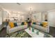 Open concept living space showcasing hardwood floors, modern decor, and open to the kitchen and dining areas at 3318 Woodland Brook Way, Wesley Chapel, FL 33543