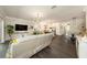 Open concept living space with living room, kitchen, and dining area featuring hardwood floors and modern decor at 3318 Woodland Brook Way, Wesley Chapel, FL 33543