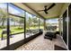Screened-in patio with a hot tub, ceiling fan, outdoor furniture and a view of the backyard at 3318 Woodland Brook Way, Wesley Chapel, FL 33543