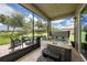 Screened-in patio with a hot tub, ceiling fan, outdoor furniture and a view of the backyard at 3318 Woodland Brook Way, Wesley Chapel, FL 33543