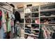 Organized walk-in closet with shelves, racks, and hanging storage for clothes and accessories at 3318 Woodland Brook Way, Wesley Chapel, FL 33543