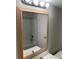 Bathroom mirror view of the tub and shower with white tile at 337 S Mcmullen Booth Rd # 157, Clearwater, FL 33759