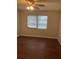 Bedroom with wood-look flooring and a window with blinds at 337 S Mcmullen Booth Rd # 157, Clearwater, FL 33759