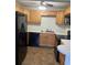 Well-organized kitchen with wood cabinets, black appliances, and ample countertop space for meal preparation and cooking at 337 S Mcmullen Booth Rd # 157, Clearwater, FL 33759
