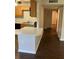Open kitchen with a breakfast bar and dark wood-look flooring at 337 S Mcmullen Booth Rd # 157, Clearwater, FL 33759