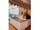 Well-lit kitchen with white cabinets, double sink, mural, and modern appliances at 337 S Mcmullen Booth Rd # 157, Clearwater, FL 33759