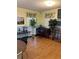 Bright living room featuring hardwood floors, a piano, and decorative plants at 337 S Mcmullen Booth Rd # 157, Clearwater, FL 33759