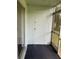 This screened patio provides an access door and a spot for outdoor relaxation at 337 S Mcmullen Booth Rd # 157, Clearwater, FL 33759