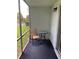 Screened patio with a chair and table providing an outdoor living space at 337 S Mcmullen Booth Rd # 157, Clearwater, FL 33759