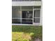 A screened patio looks out onto a manicured lawn for outdoor enjoyment at 337 S Mcmullen Booth Rd # 157, Clearwater, FL 33759