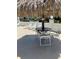 This outdoor seating area by the pool is shaded by a tiki hut at 337 S Mcmullen Booth Rd # 157, Clearwater, FL 33759