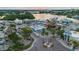 Aerial view of an intersection with nearby shops, a sunset, and waterfront properties with docks at 346 Gray Oak Dr, Tarpon Springs, FL 34689