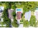 Aerial view of a home with a backyard pool, mature trees, and well-maintained landscaping at 346 Gray Oak Dr, Tarpon Springs, FL 34689