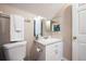 Bathroom vanity with white cabinets, a mirror, and a toilet, providing a functional space at 346 Gray Oak Dr, Tarpon Springs, FL 34689