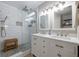 Modern bathroom features a glass shower with a pebble floor and dual sink vanity at 346 Gray Oak Dr, Tarpon Springs, FL 34689