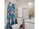 Small bathroom featuring a sink, toilet, and tub/shower combo with a leafy shower curtain at 346 Gray Oak Dr, Tarpon Springs, FL 34689