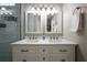 Beautiful bathroom with double sinks, quartz countertops, modern lighting, and white subway tile in shower at 346 Gray Oak Dr, Tarpon Springs, FL 34689