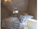 Bedroom with slanted ceilings and a brightly lit nightstand at 346 Gray Oak Dr, Tarpon Springs, FL 34689