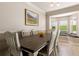 Bright dining room with a large wooden table, stylish chairs, and a cozy window seat at 346 Gray Oak Dr, Tarpon Springs, FL 34689