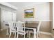 Elegant dining room with a rustic table, crown molding, and a picturesque painting on the wall at 346 Gray Oak Dr, Tarpon Springs, FL 34689