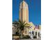 Exterior view of the church tower, palm tree, and American flag against a clear sky at 346 Gray Oak Dr, Tarpon Springs, FL 34689